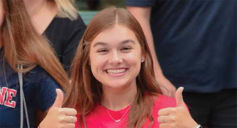 Duquesne student smiling with two thumbs up