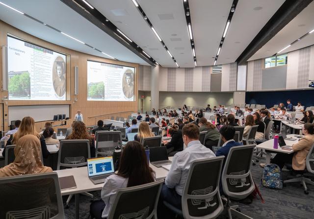 Students in COM lecture hall watching a presentation