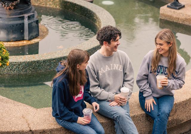 Student sitting by fountain