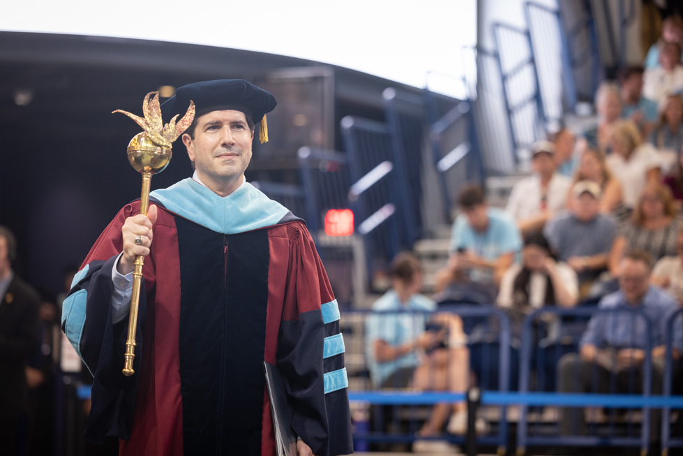 Dr. Dausey, as provost, leads matriculation procession carrying academic mace
