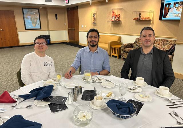 students sitting at a formal table setting during previous etiquette dinner