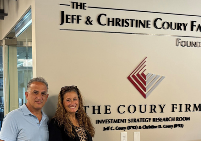 Jeff and Christine Coury in the ISI in front of The Jeff & Christine Coury Family Foundation and The Coury Firm dedicated wall on the 6th Floor of Rockwell Hall