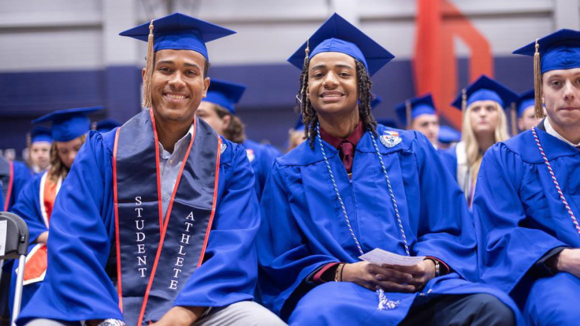 Excited graduates wait for commencement to begin.