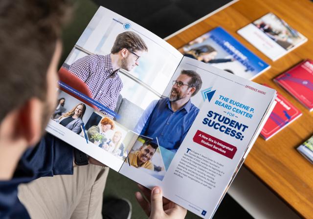 Student looks at brochures