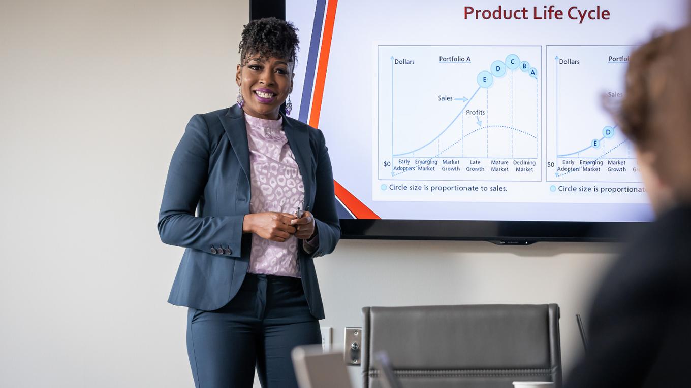 A woman presents in a conference room.