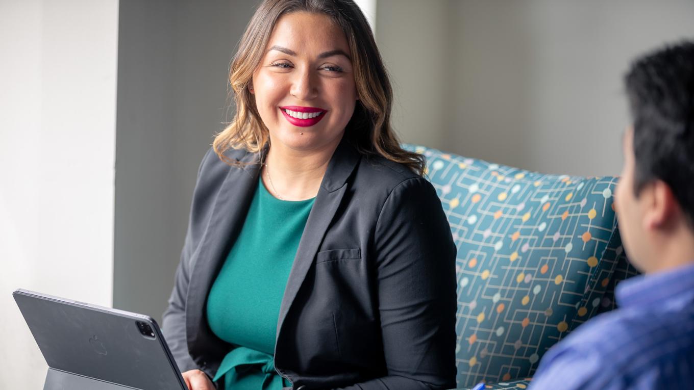 A young professional woman smiles.