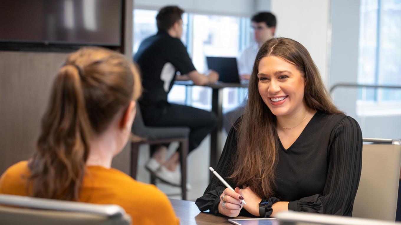 A student smiles during a meeting. 