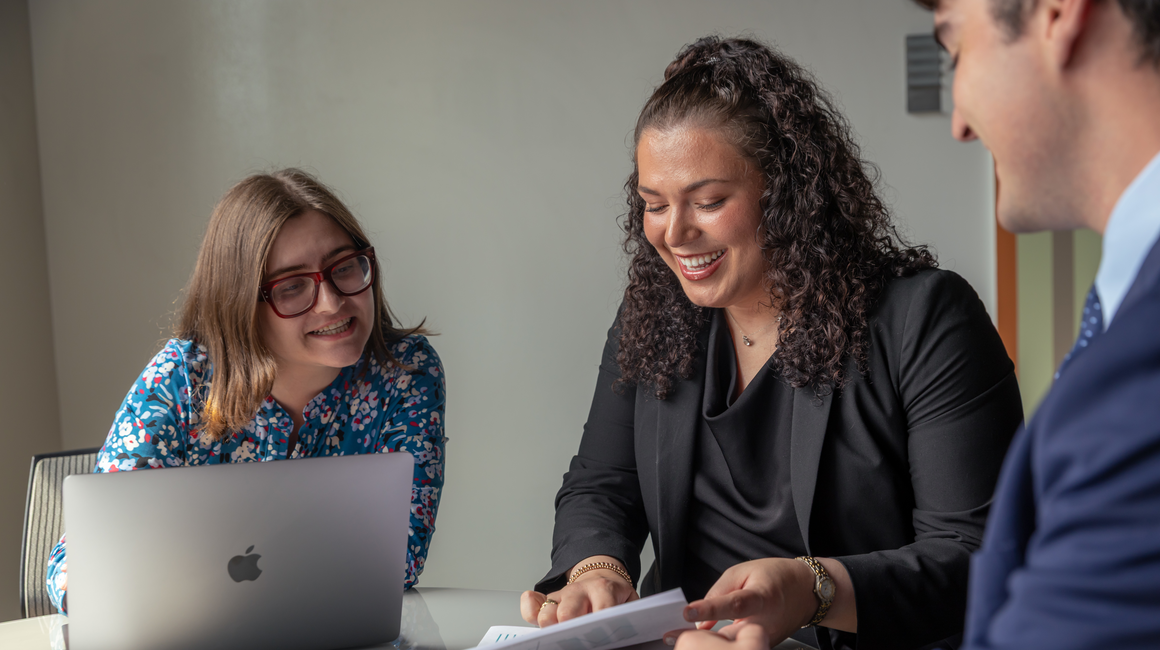 Two professionals review documents.