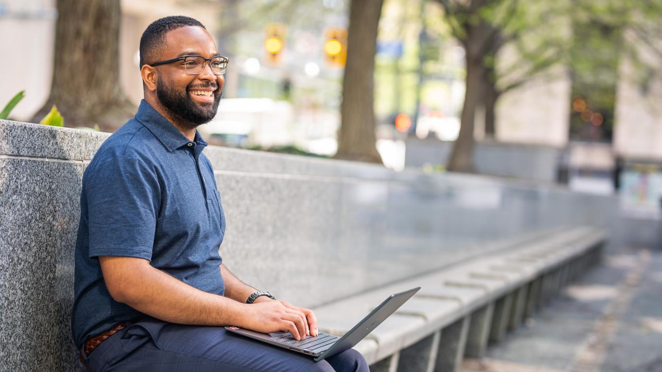 A student uses a laptop in downtown Pittsburgh.