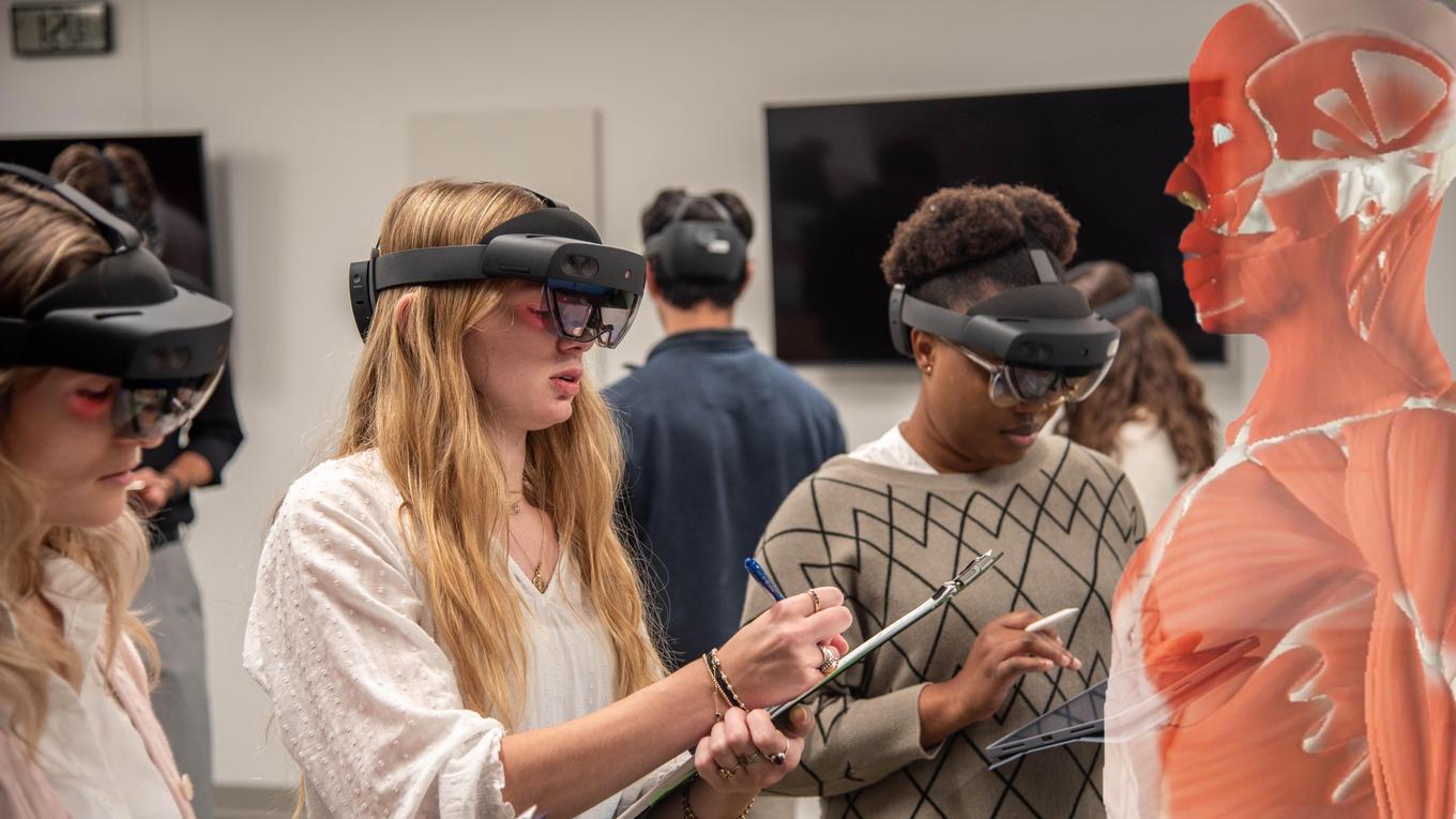 DUQCOM MBS students work alongside faculty exploring the holoanatomy augmented reality tech for anatomy class.