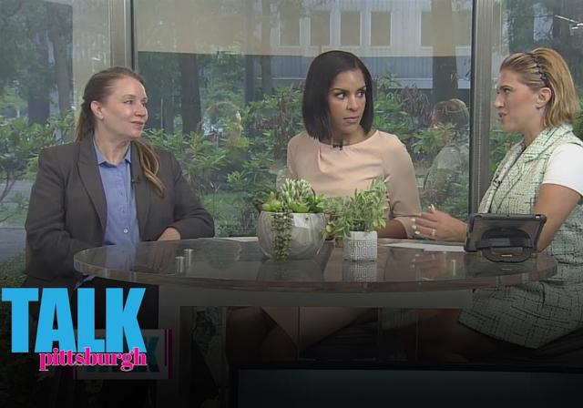 Dr. Tammy Hughes conversing at table on set of Talk Pittsburgh with two hosts.