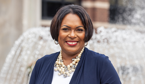 School of Education Dean Generett on campus in front of Canevin Hall and fountain