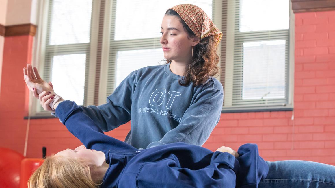 OT student doing exercises with patient