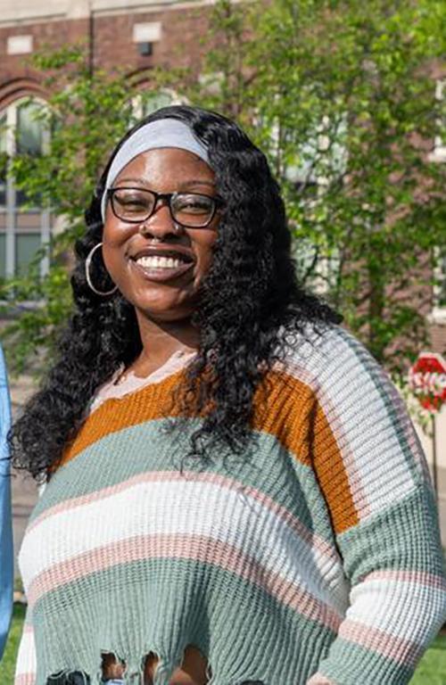 Public Health Grads standing in front of Rangos School of Health Sciences