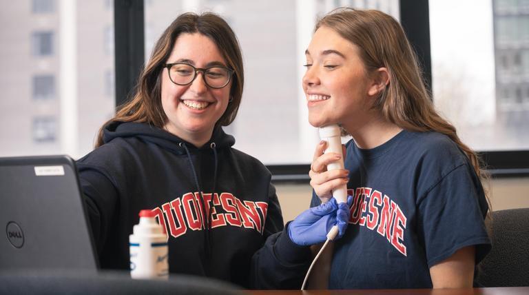 Happy SLP students using voice equipment.