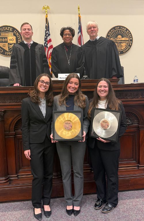 Music law team with judges and trophies