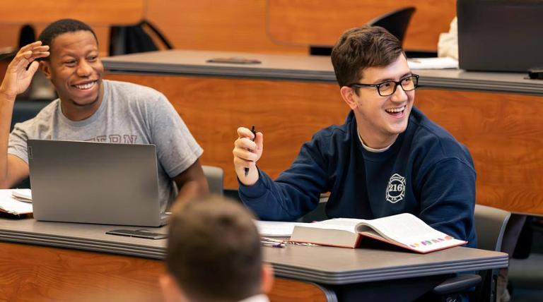 Two students smiling in class