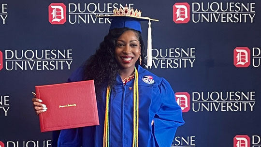 Candis Dorsey posing at commencement