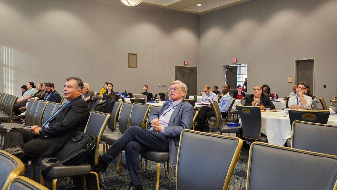 Attendees sitting in the crowd listening to the lectures.