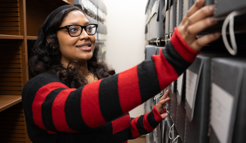 Alyssa selects box in archives.