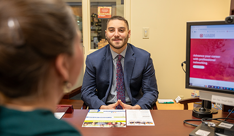 Gabe Sanders speaks with a career consultant in the Student Union.