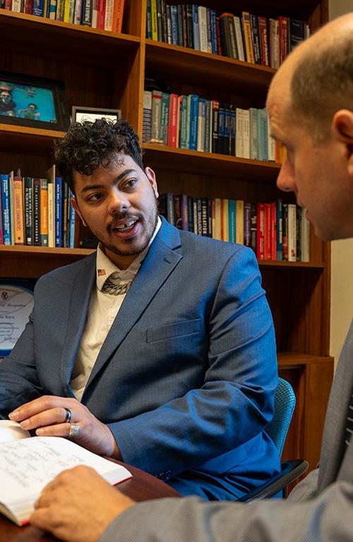 Zavier Chambers speaks with Associate Dean John Kern during office hours.