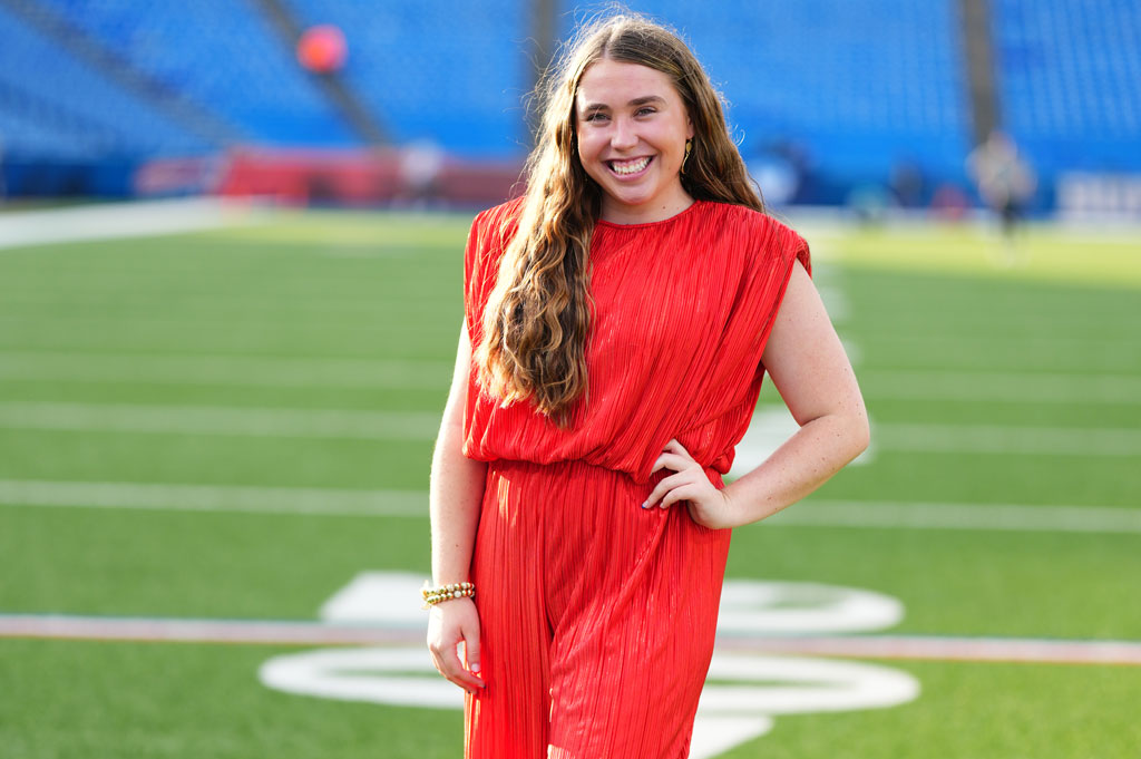Grace Heidinger poses on a football field.