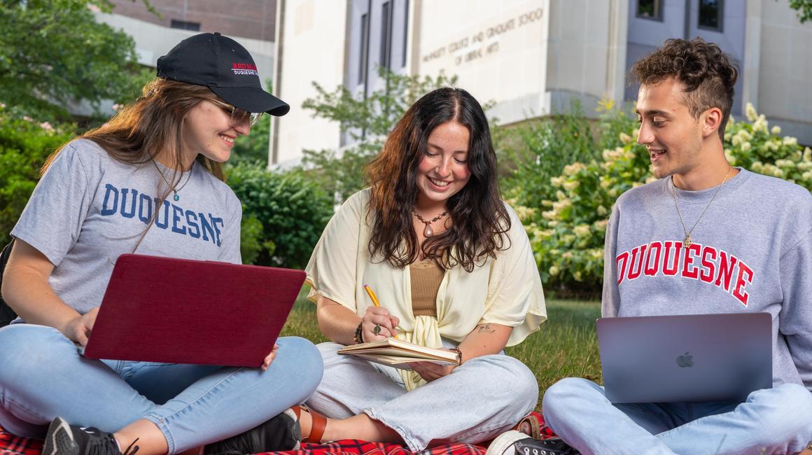 Students studying outside College Hall.