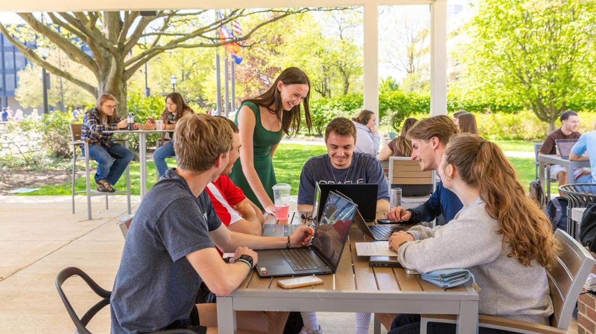 Students studying outside under pavilion