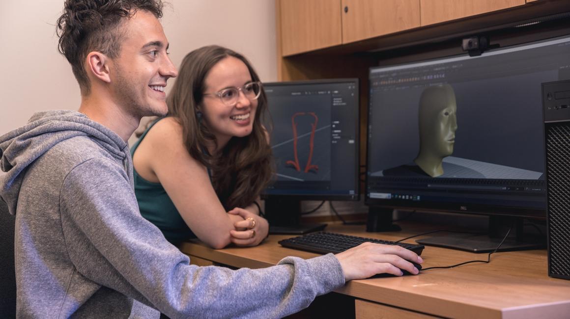 Two students create a design in Blender.