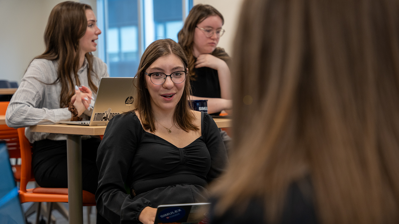 Student engaging in a class discussion with peers.
