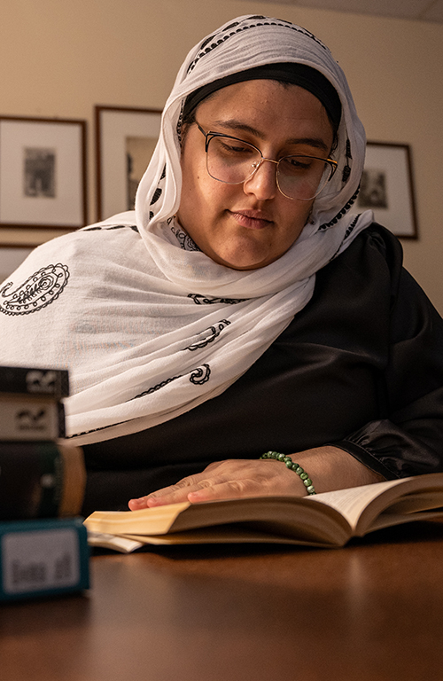 Jasmin reading a book in a phenomenology archive.