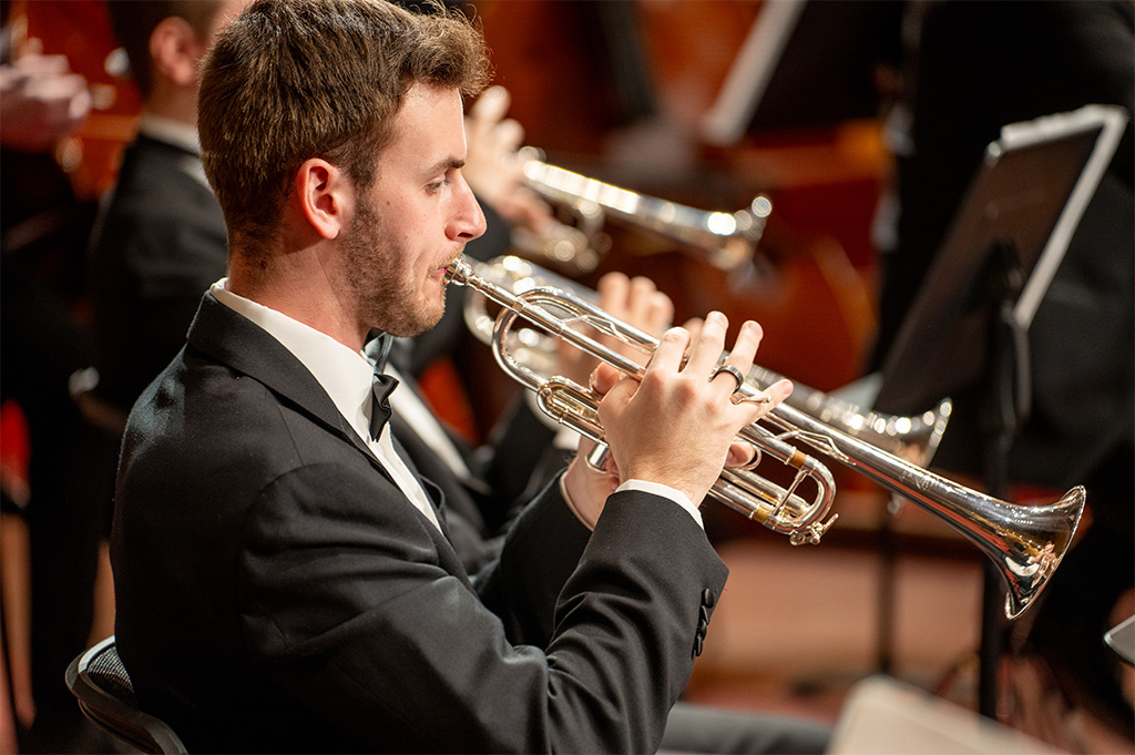 A trumpet player performs on stage.