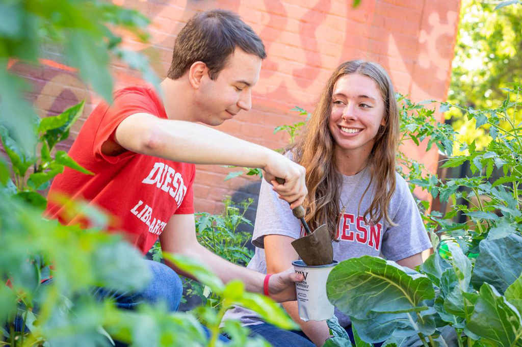 Two people garden.