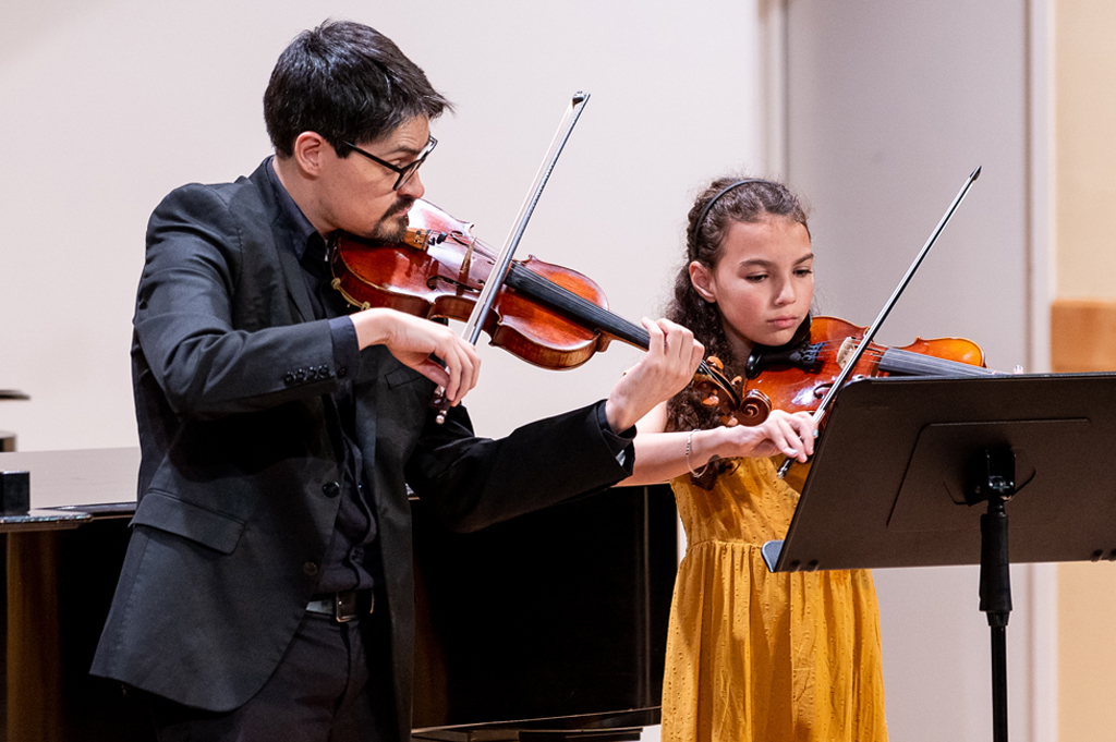 Violin lesson with student and teacher