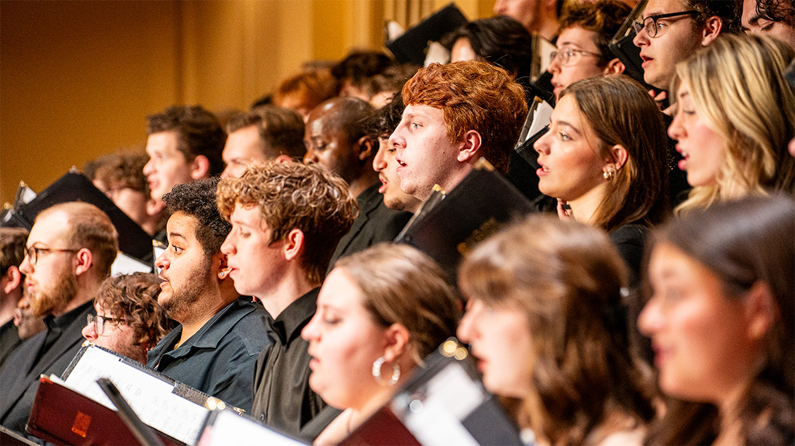 A choir performs on stage.