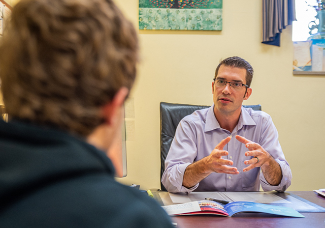 A person talks with a prospective student.