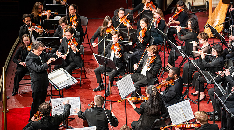 The Duquesne Symphony Orchestra performs on stage.