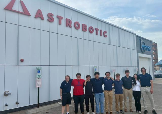 a group of people outside of a research facility