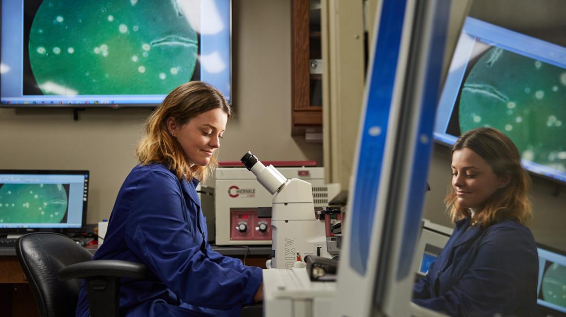 girl looking in a microscope