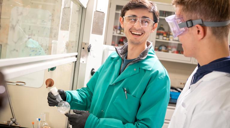 boy holding a beaker