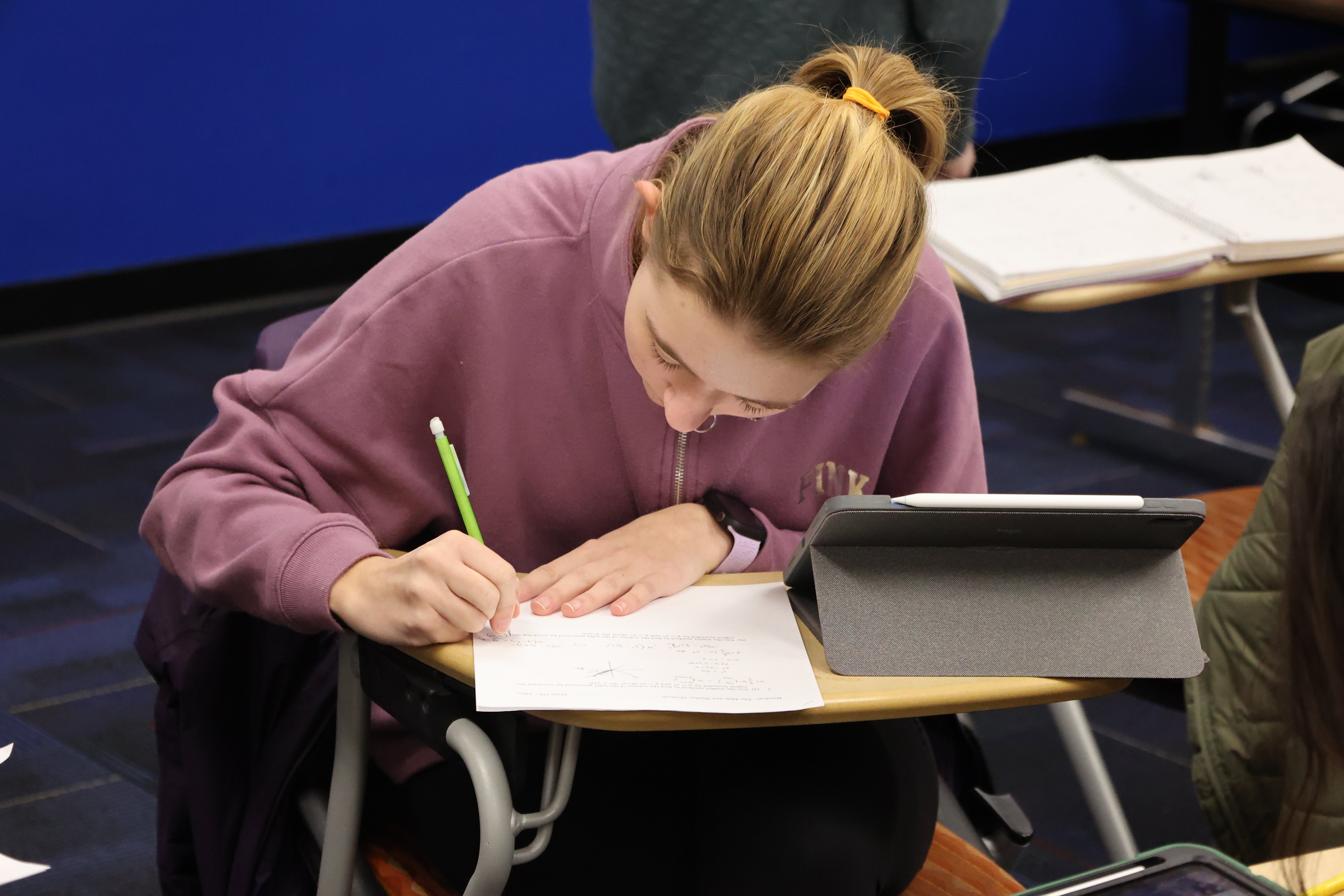 a girl writing on paper