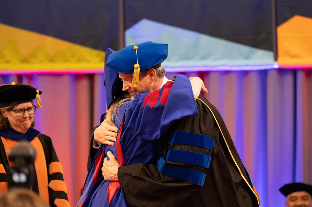 people hugging at graduation