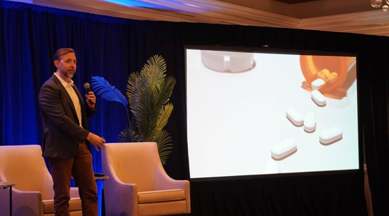 speaker at the carfang conference on stage