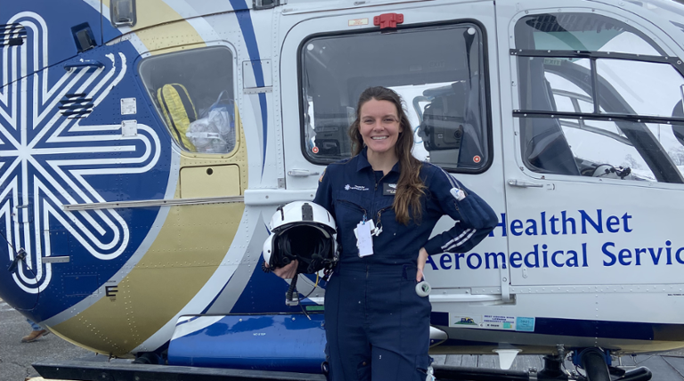 kayla wright, flight nurse standing near a helicopter