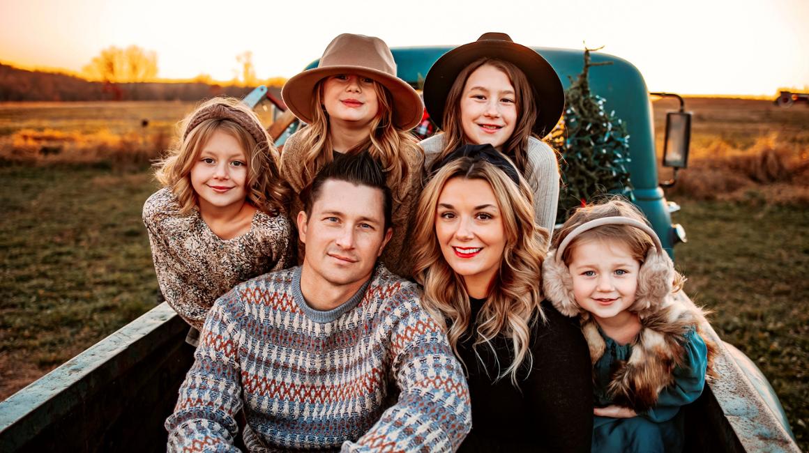 Carrie Blasko poses with her family for a photo.