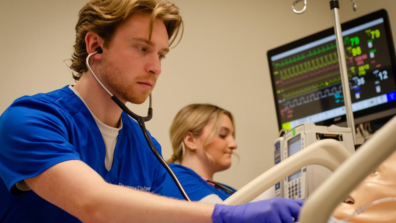 male nurse checking on a patient
