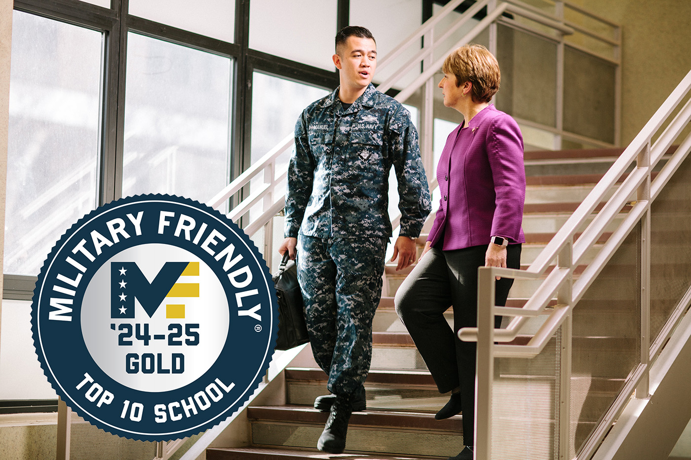 Man in US Navy uniform conversing with staff with #1 Military-friendly school seal overlaid