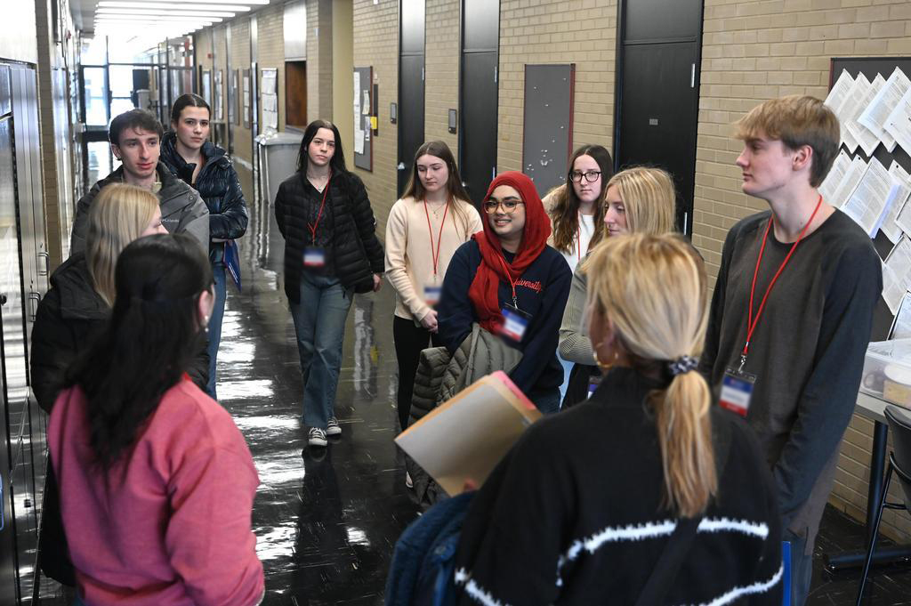 a professor and prospective students discussing the school of pharmacy