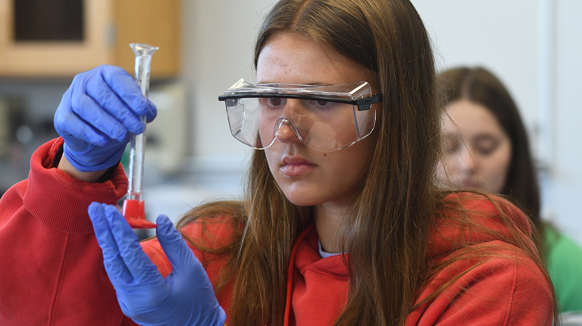 a prospective student with a graduated cylinder